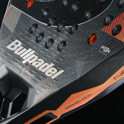 Close-up of the Bullpadel Neuron 02 Edge 2026 padel racket, highlighting its black and gray textured surface with orange accents, prominent Bullpadel branding, model details, and advanced PrismLock technology near the handle.