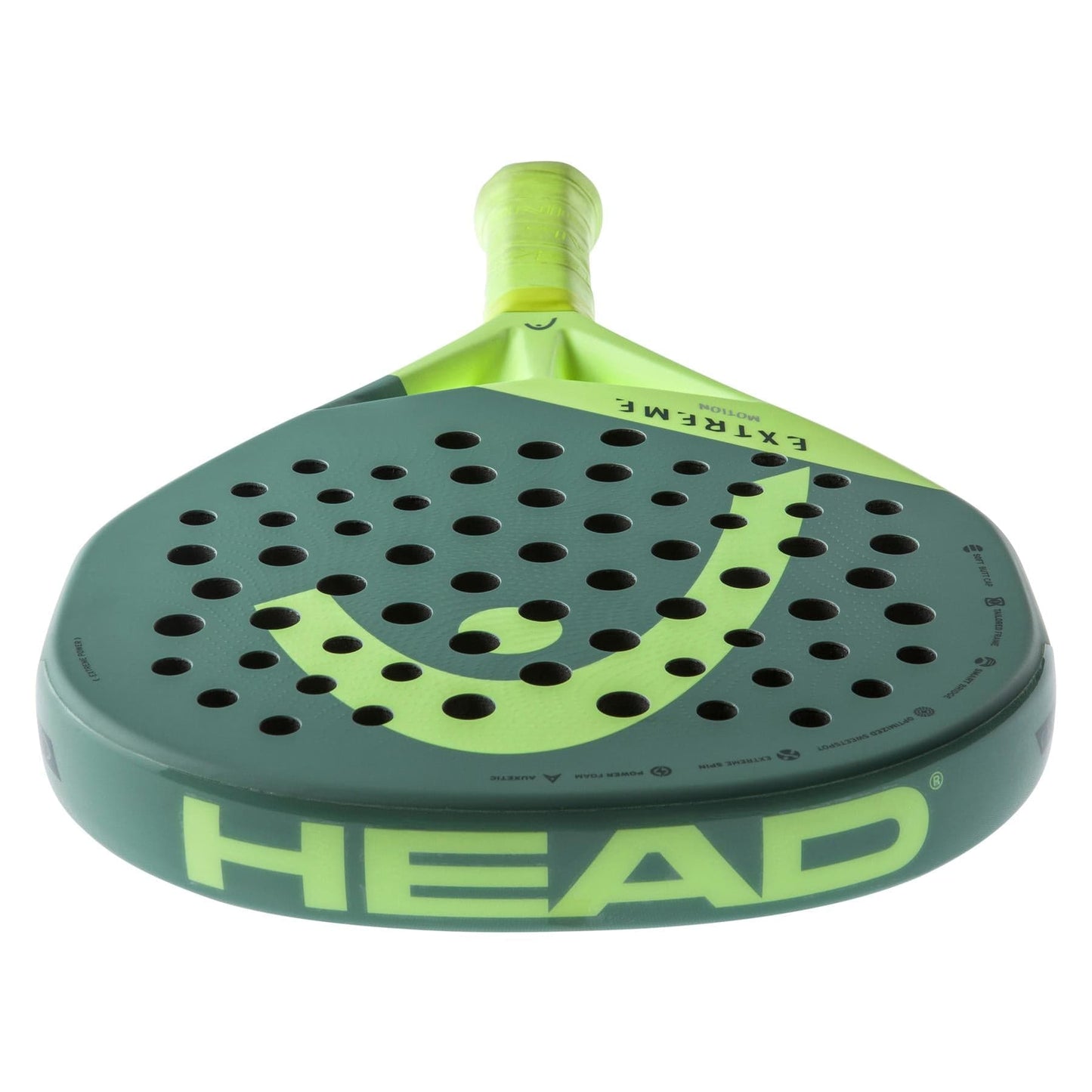 The HEAD Extreme Motion 2023 padel racket, in green and yellow with a perforated face and prominent HEAD branding, is displayed upright and features innovative Auxetic technology.