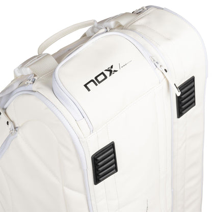 Close-up of the NOX Pro Series Padel Racket Bag in white, featuring a handle, black accents, "NOX" logo on top, 45L capacity, zippers, and textured black vents on the corners.