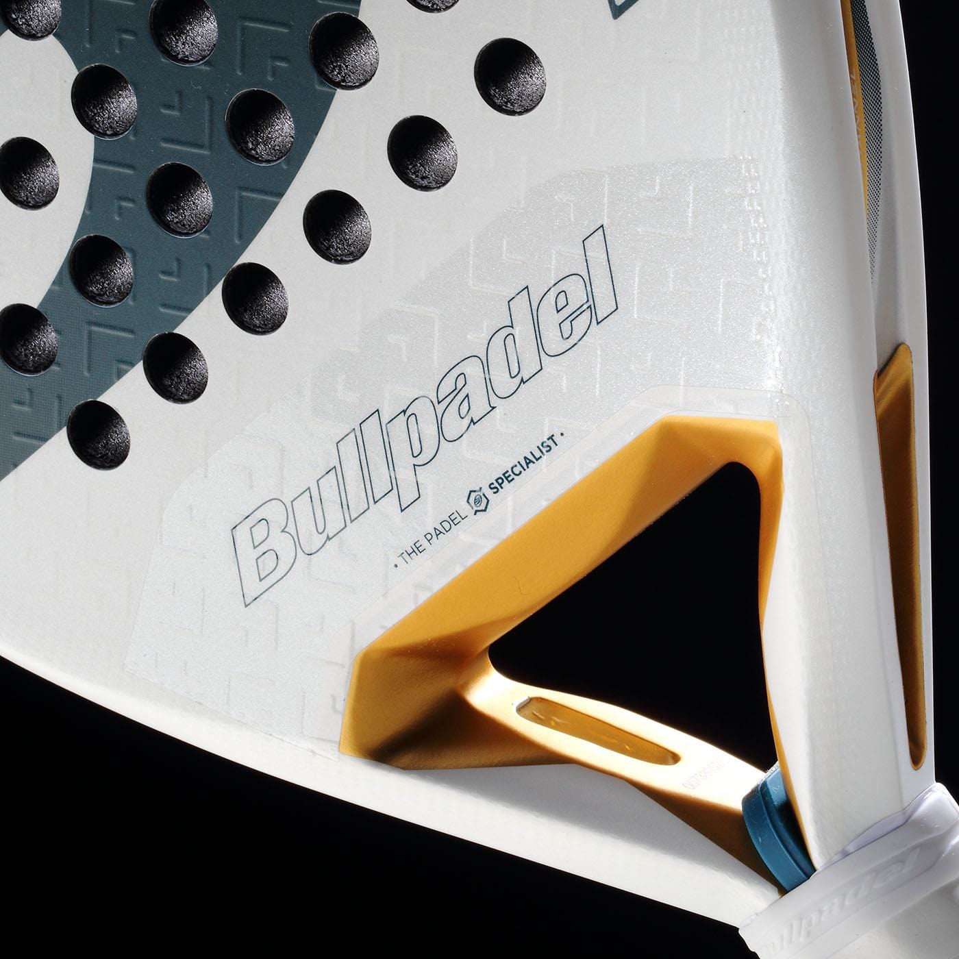 Close-up of the Bullpadel Pearl 2026 Padel Racket by Bullpadel, a lightweight racket featuring textured black dots, gold triangular cutout, and branding, designed to reduce arm fatigue, shown against a black background.