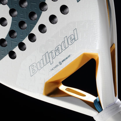 Close-up of the Bullpadel Pearl 2026 Padel Racket by Bullpadel, a lightweight racket featuring textured black dots, gold triangular cutout, and branding, designed to reduce arm fatigue, shown against a black background.