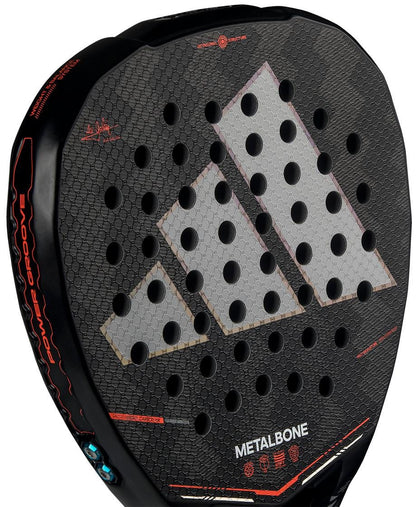 Close-up of the adidas Metalbone by Ale Galán 2026 Padel Racket, highlighting its textured Spin Blade Decal surface, multiple round holes, bold gray-red triangular design, and "METALBONE" printed near the bottom edge.