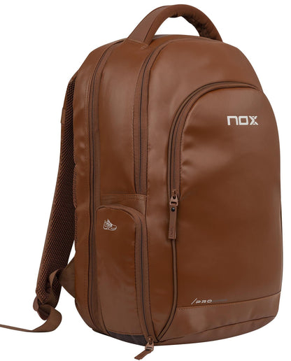 The NOX Pro Series Padel Backpack - Camel by NOX features multiple zippered compartments, a top handle, padded shoulder straps, and an air ventilation system—ideal for carrying sports or padel essentials comfortably.