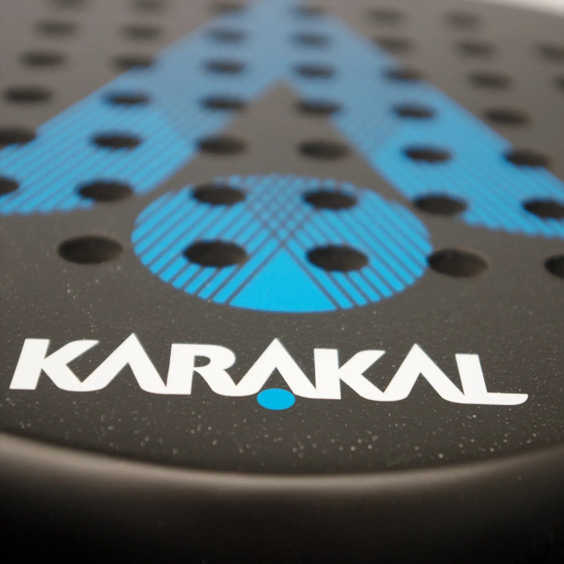 Close-up of the Karakal Air Lite 345 Blue Padel Racket, a lightweight model with blue dotted and striped design, featuring "Karakal" in white letters near the edge.