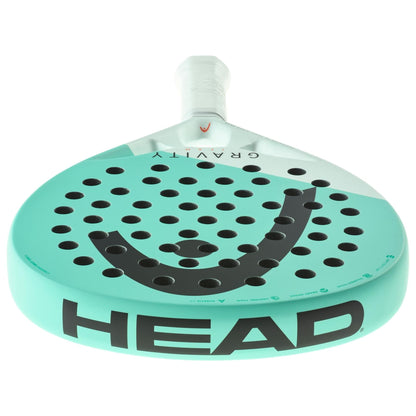 The HEAD Gravity Team 2024 Padel Racket for intermediate players features turquoise and white colors, Auxetic 2.0 tech, black branding, a perforated surface, and a white grip, shown from the front.