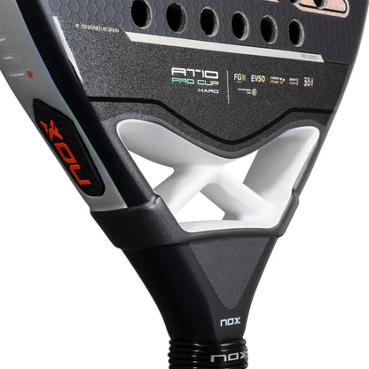 Close-up of the NOX AT10 Pro Cup HARD By Agustin Tapia 2025 padel racket, showing a black design, Smartstrap, white bridge supports, branding details, and textured surface.