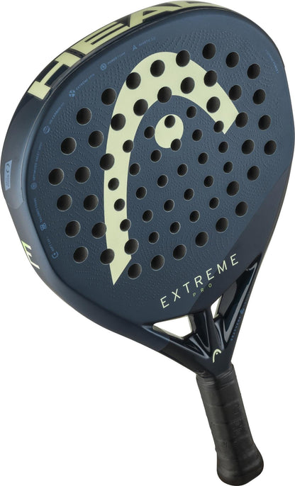 A close-up of the HEAD Extreme Pro 2025 Padel Racket by HEAD, featuring a dark blue design, black handle, circular holes on the surface, and light yellow branding that highlights this power racket’s sleek look.