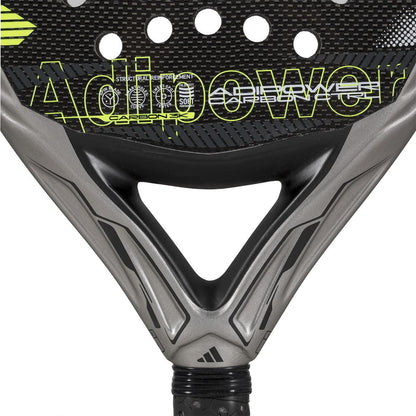 Close-up of the lower section of the adidas ADIDAS Adipower Carbon CTRL 3.4 Padel Racket in black and gray with yellow accents, featuring "Adipower" on its carbon 18K fiber surface.