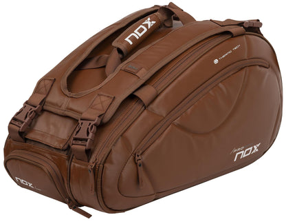 The NOX Pro Series Padel Racket Bag - Camel is a spacious 45L bag featuring multiple compartments, sturdy handles, and the NOX brand logo on the side and straps.