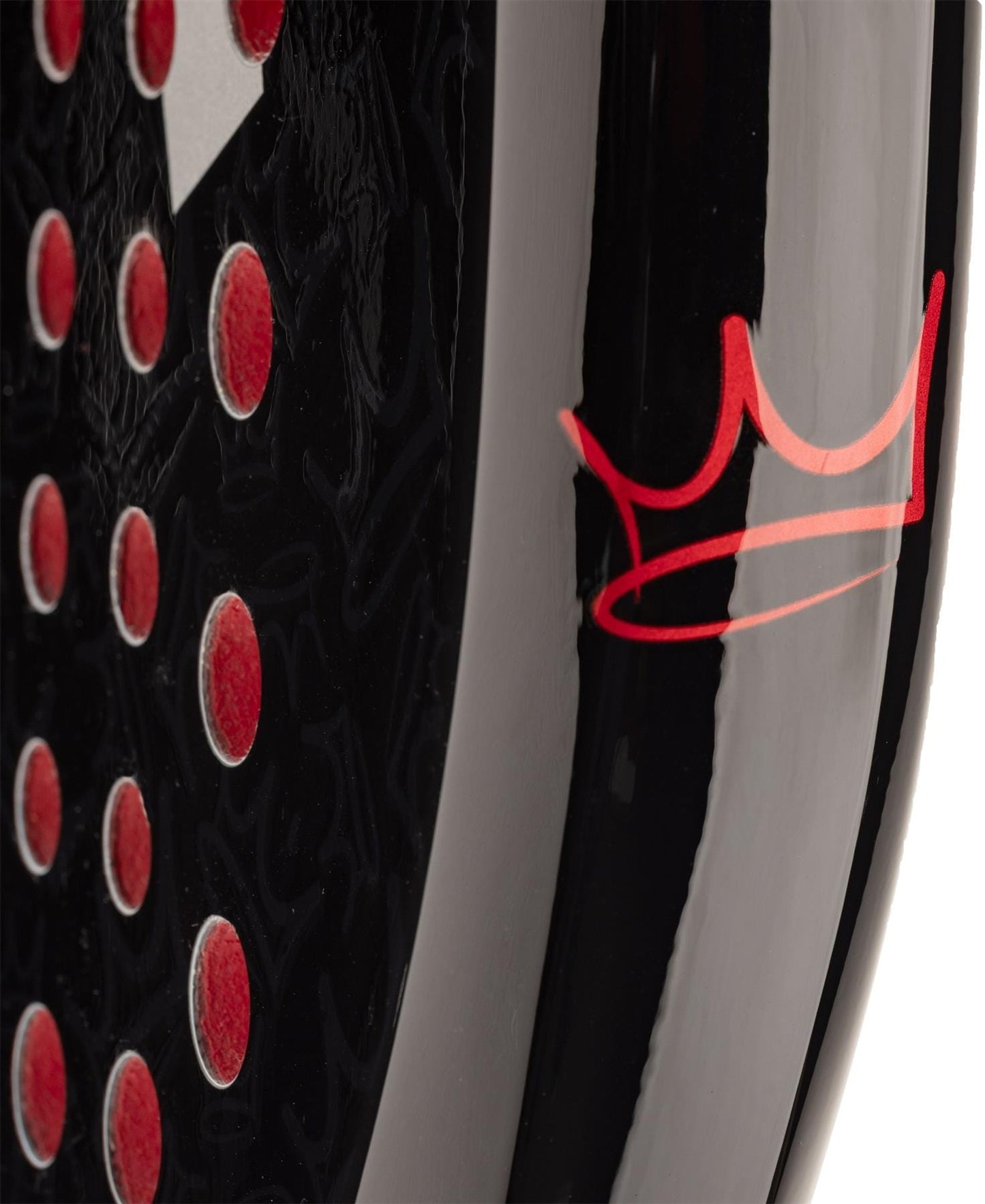 Close-up of the HEAD Coello Team 2025 Padel Racket by HEAD, showing its black surface with red circular holes and a red crown logo, featuring Auxetic 2.0 technology for superior sports performance.