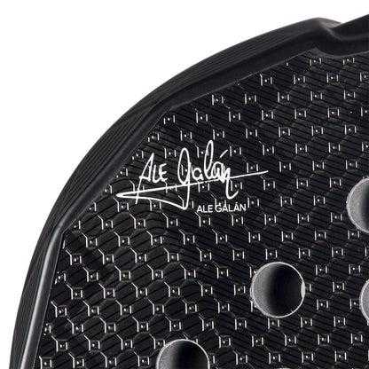 Close-up of the adidas Metalbone 3.4 Padel Racket, featuring a black design with a hexagonal texture, round holes, and Ale Galán’s white signature—engineered for advanced padel performance.