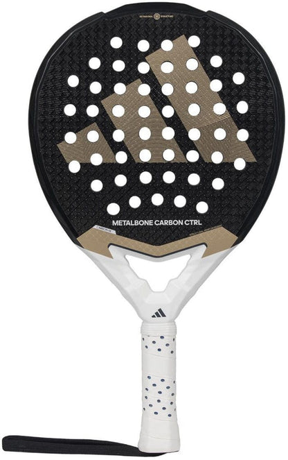 The adidas Metalbone Carbon CTRL 3.4 padel racket features a black and gold design with a white handle, black wrist strap, and circular hole pattern. Ideal for advanced players, its model name appears on the front.