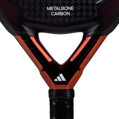 Close-up of the adidas Metalbone Carbon 3.3 padel racket for advanced players, displaying “METALBONE CARBON” on the face and a white adidas logo on the neck above the handle.