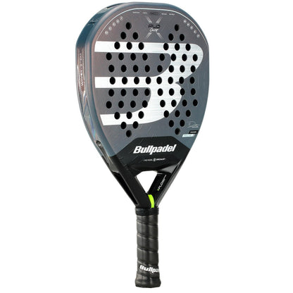 The Bullpadel XPLO Comfort 2026 Padel Racket has a teardrop shape, black and grey design with a bold white "B" logo, multiple round holes, and a black grip—crafted by Bullpadel for outstanding comfort and explosive court power.