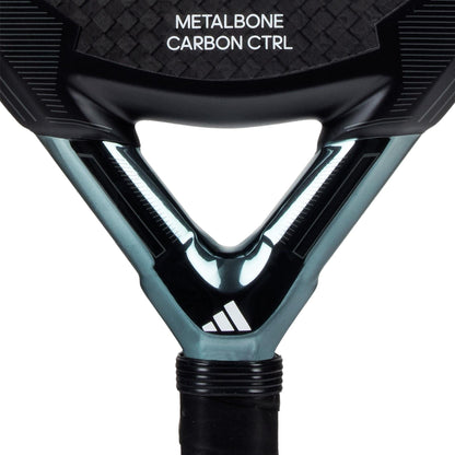 Close-up of the adidas ADIDAS Metalbone Carbon CTRL 3.3 padel racket in black, highlighting "METALBONE CARBON CTRL" on the throat and a white logo on the neck; sleek design enhanced by a Spin Blade Decal for a modern aesthetic.