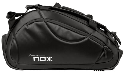 The NOX Pro Series Padel Racket Bag - Black features a sleek design, side zipper pocket, “Pro Series” and “NOX” print, multiple straps, padded panels, and ample storage for your gear.