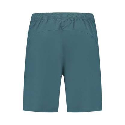 Back view of elastic waistband teal shorts, crafted from four-way stretch polyester, offering a smooth and lightweight feel ideal for sports or exercise activities like wearing K-Swiss Hypercourt 7" Men's Padel Shorts 2 - Stargazer during a match.