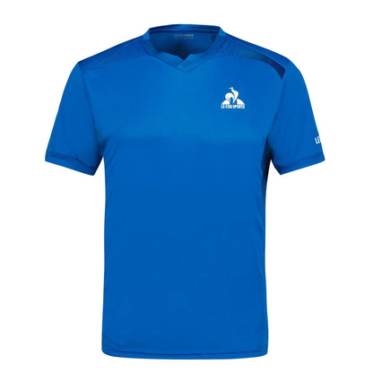 The Le Coq Sportif Pro Men's Padel T-Shirt in Lapis Blue features a V-neck and short sleeves. A small white rooster logo with the "Le Coq Sportif" text is positioned on the left chest, providing excellent breathability for comfortable wear.