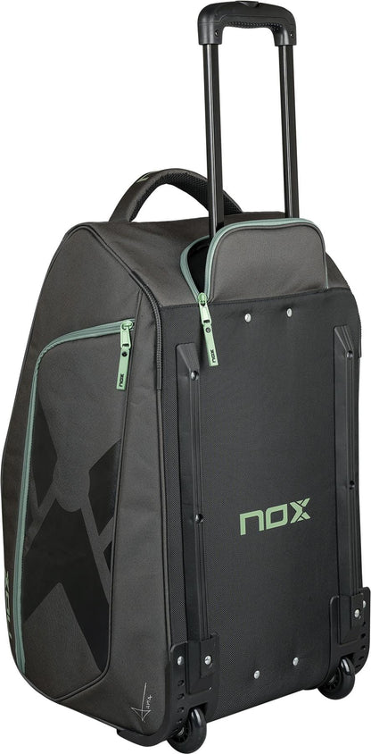 The NOX AT10 Competition Trolley Padel Racket Bag in black and green features an extended handle, two wheels for easy transport, and the NOX logo on the front—ideal as a spacious, wheeled padel bag.