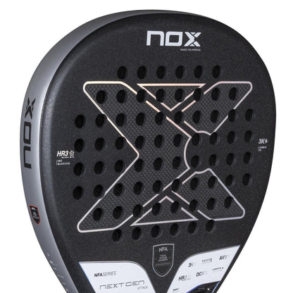 Close-up of the NOX NFA Nextgen Pro Attack 3K padel racket by NOX, showing its textured face, round holes, bold "X" design, and visible branding with model details at the top and side.