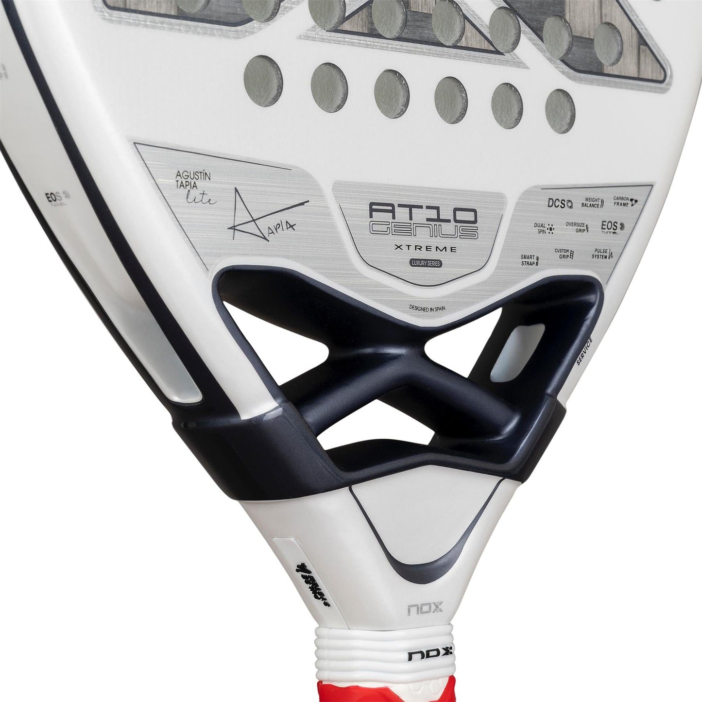 Close-up of the NOX AT10 Genius 12K Alum Extrem Lite by Agustín Tapia 2026 Padel Racket, with a white base, black and grey details, “AT10 Genius Extreme” text, player signature, perforated surface, visible handle, and advanced Weight Balance system.
