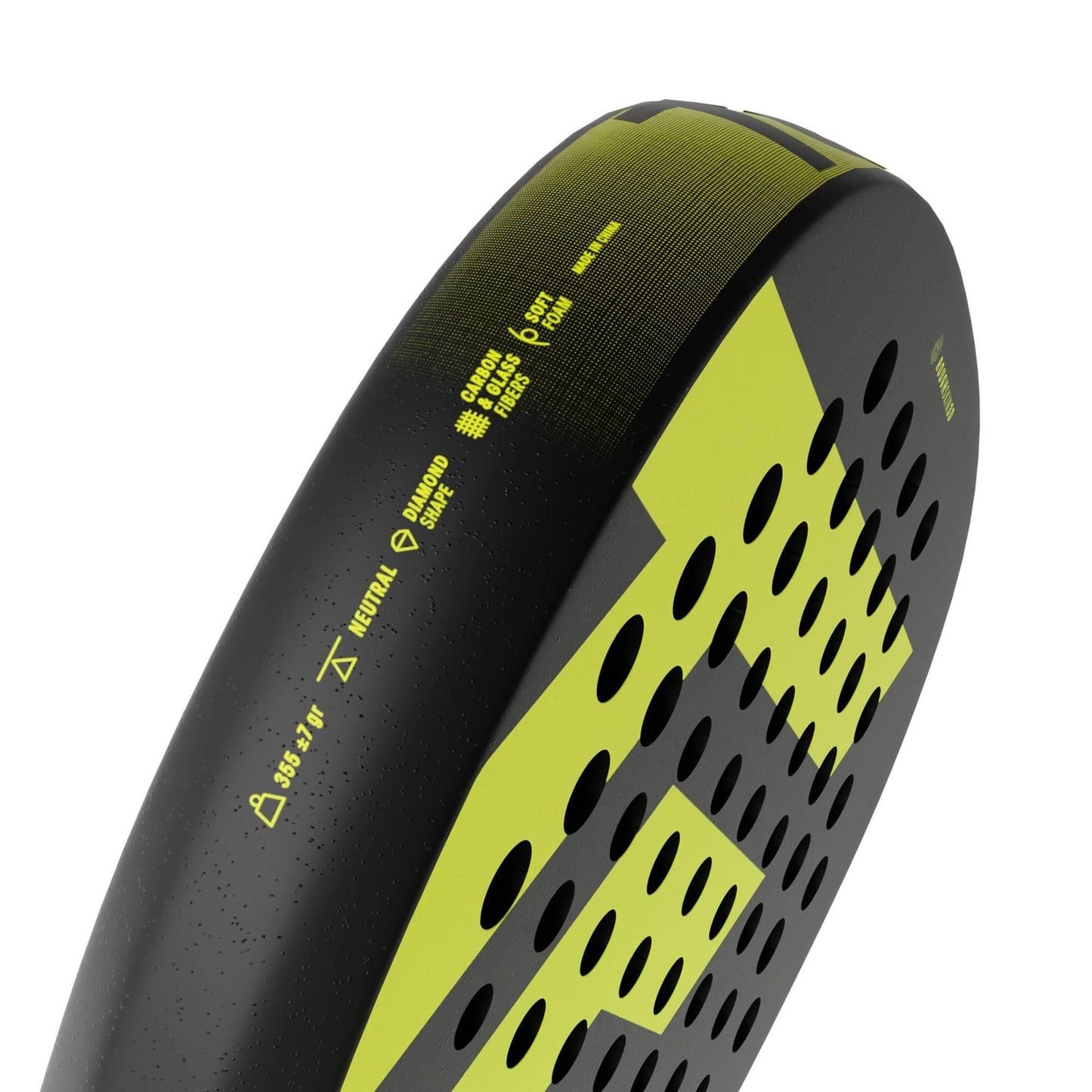 Close-up of the edge of the Tecnifibre Bomba Soft Padel Racket by Tecnifibre, highlighting perforated holes and technical details on its black and yellow fibreglass frame designed for comfort.