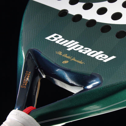 Close-up of the Bullpadel Icon 2026 Padel Racket in green and white, featuring the brand name, carbon fiber texture, a triangular frame by the handle, and design for performance inspired by Juan Martín Díaz.