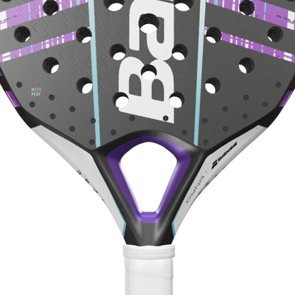 Close-up of the Babolat Dyna Spirit Padel Racket, featuring a teardrop headshape, black, grey, purple, and white colors, a triangular hole near the handle, circular holes on the face, and a partially visible Babolat logo.