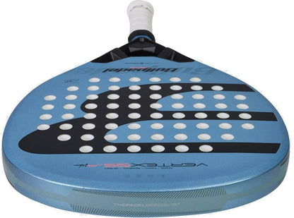The Bullpadel Vertex Junior Girls 2026 Padel Racket features a blue design with white grip tape, circular holes on the face, black and white graphics, and prominent Bullpadel branding and model details on the face and edge.
