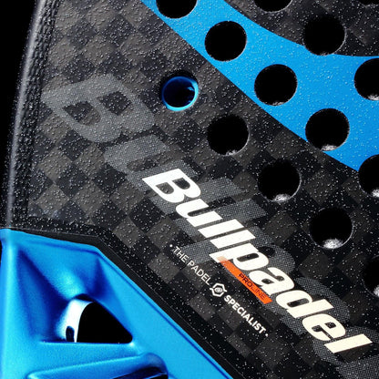 Close-up of the Bullpadel Vertex 05 Hybrid 2026 padel racket, featuring a textured black surface with blue accents, perforated holes, and branding text including "Bullpadel" and "THE PADEL SPECIALIST.