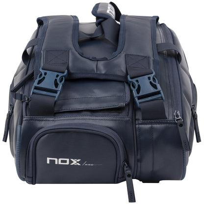 The NOX Pro Series Padel Racket Bag - Blue features black zippers, padded shoulder straps, a front pocket with a white NOX logo, and ThermoTech technology for secure storage of athletic gear or padel rackets.