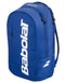 The Babolat Court Lite Padel Backpack in dark blue features white logo lettering and two zippered compartments, including a dedicated racket space. Shown angled on a plain background.