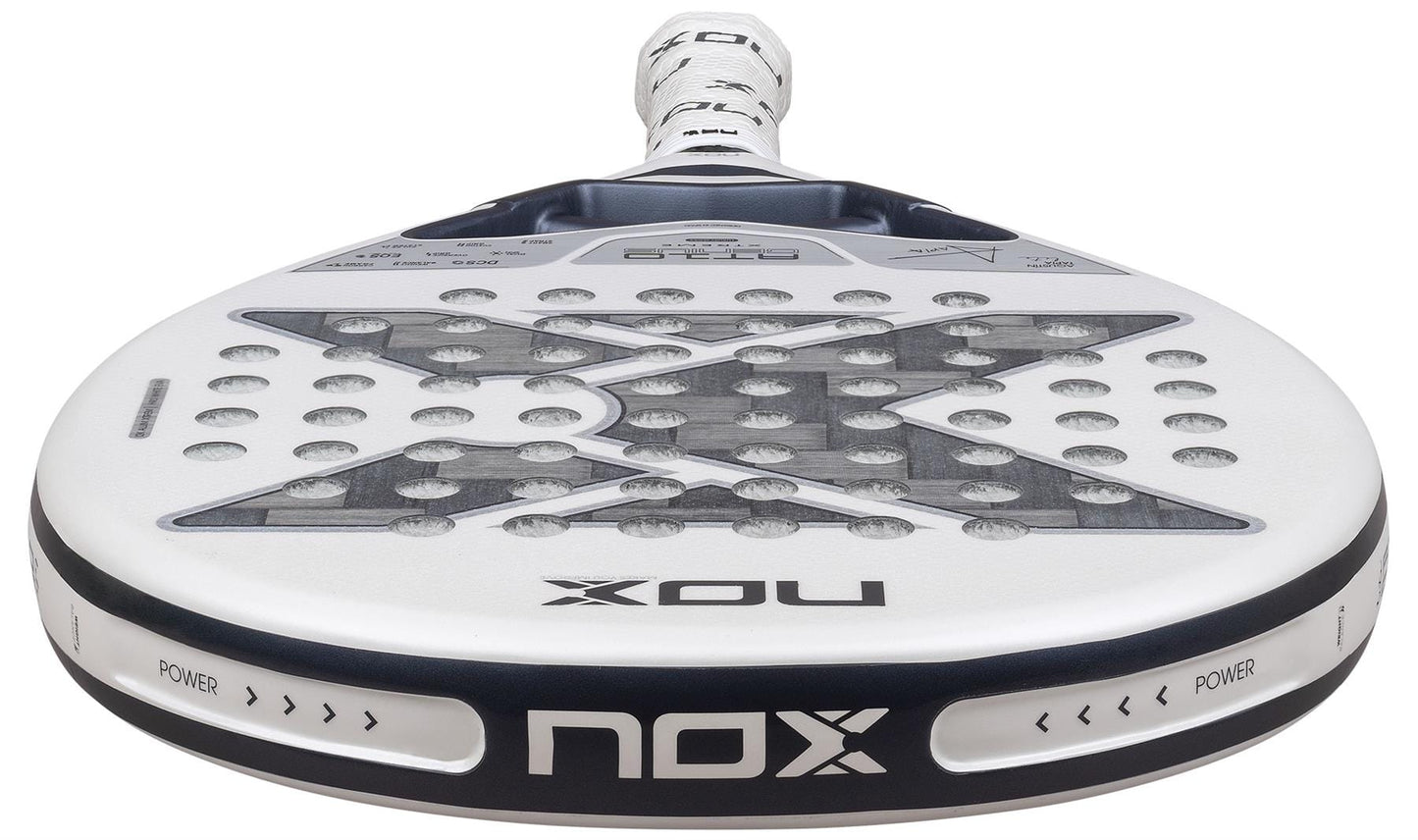 Close-up of the NOX AT10 Genius 12K Alum Extrem Lite By Agustín Tapia 2026 padel racket, mainly white with black details, bold "X" design, and visible NOX branding highlighting its advanced weight balance system.