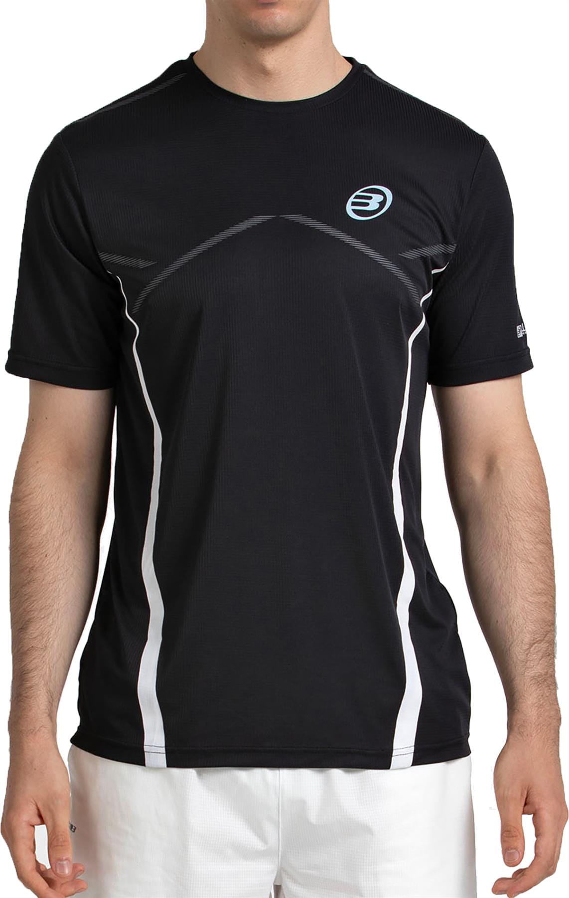 A man in a Bullpadel Cabore Men's Padel T-Shirt - Black from Bullpadel, featuring quick-drying fabric, white accents, and a small blue logo, pairs it with white shorts while standing against a plain background.
