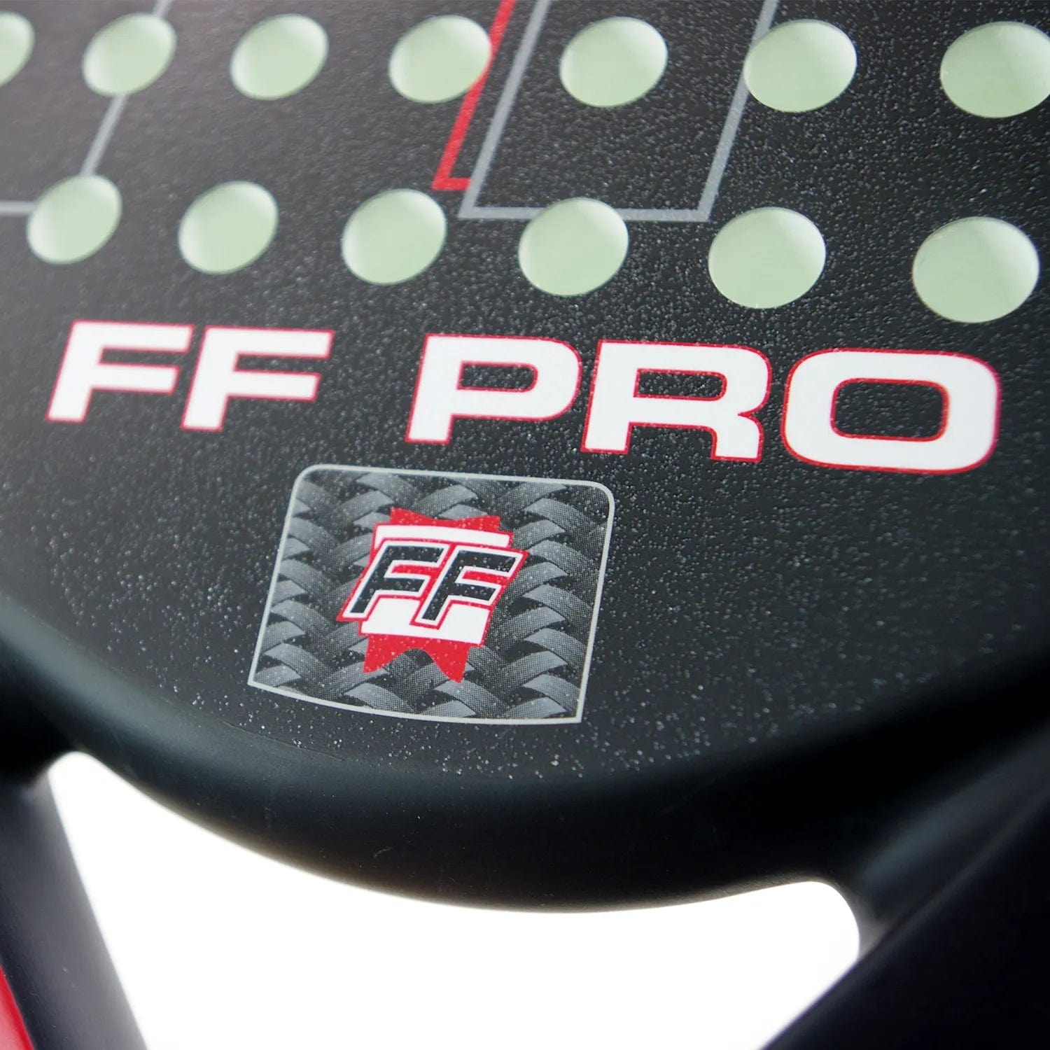 Close-up of the Karakal FF Pro 375 Padel Racket, a black advanced-level paddle with "FF PRO" in white and red, a carbon fiber pattern square featuring the red and white FF logo, and circular holes by Karakal to boost spin.