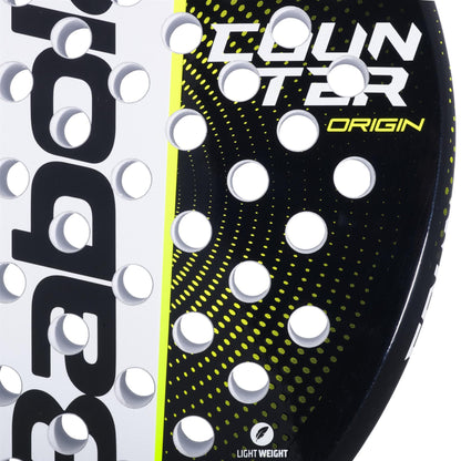 Close-up of the Babolat Counter Origin Padel Racket by Babolat, featuring circular holes, yellow accents, "COUNTER ORIGIN" text, a dotted pattern design, and a "LIGHT WEIGHT" icon at the bottom.