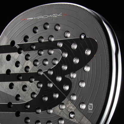 Close-up of the Bullpadel HACK 04 Hybrid 2026 padel racket in black, featuring a modern design with circular perforations, glossy finish, subtle gray stripes, branding details, and advanced Total Channel technology.