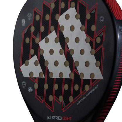 Close-up of the lightweight adidas RX Series Light Padel Racket, featuring black and red geometric accents, a large white adidas logo, round holes, and "RX SERIES LIGHT" and "STRUCTURAL REINFORCEMENT" printed on it.