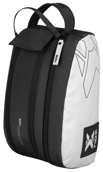 The NOX Luxury Travel Kit Bag – Black/Grey is a versatile organiser with two zippered compartments, top handle, and minimalist NOX logos on the side and front—ideal as a sports shoe bag or travel kit.