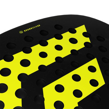 Close-up of the Tecnifibre Bomba Soft Padel Racket from Tecnifibre, showing its black surface with large yellow geometric shapes, evenly spaced round holes, and "ROUGH SKIN 3D" text in yellow near the top left corner.