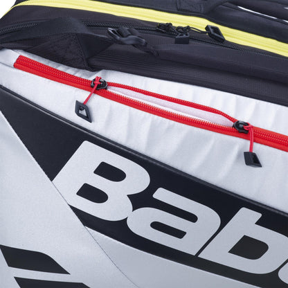 Close-up of the Babolat RH Pro Padel Racket Bag in Black/Silver, featuring bold Babolat branding, red and yellow zippers, an insulated racket compartment for protection, and large capacity for all your padel gear.