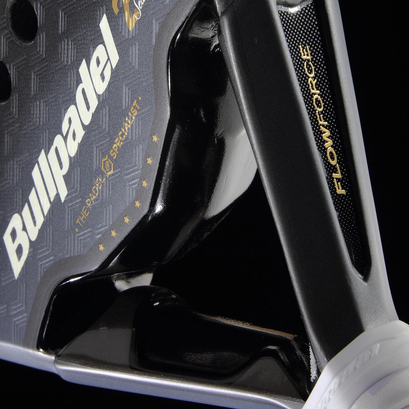 Close-up of the Bullpadel Flow Legend 2026 Padel Racket by Bullpadel, showcasing its logo, textured black and gray surface, gold "THE RADY SPECIALIST" text with stars, and "FLOWFORCE" technology—all against a dark background.