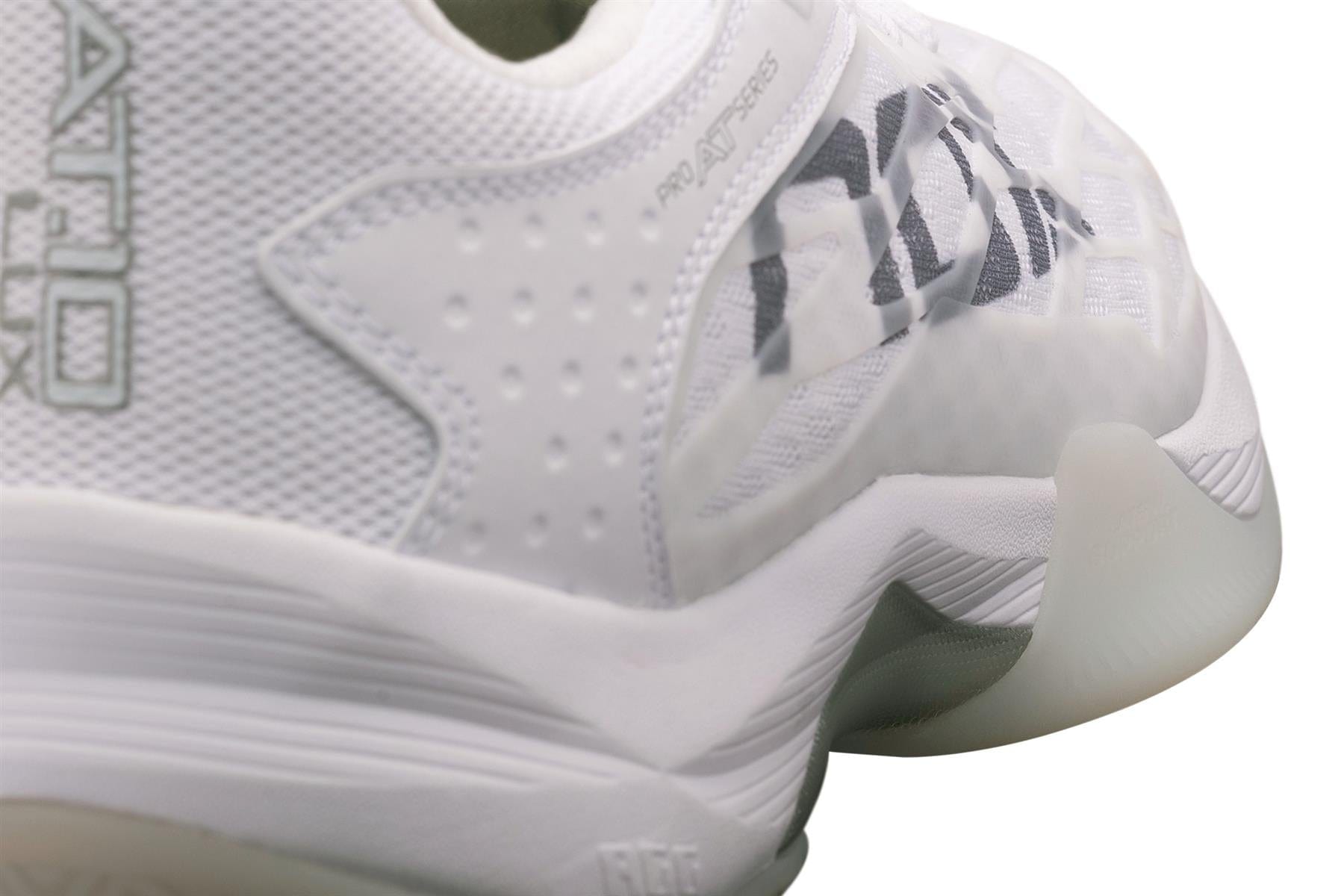 Close-up of the NOX AT10 Lux Men's Padel Shoes in White/Grey, designed for Agustin Tapia. These premium shoes from NOX feature textured details, mesh panels, a thick curved sole with translucent rubber, and a black logo on the side.