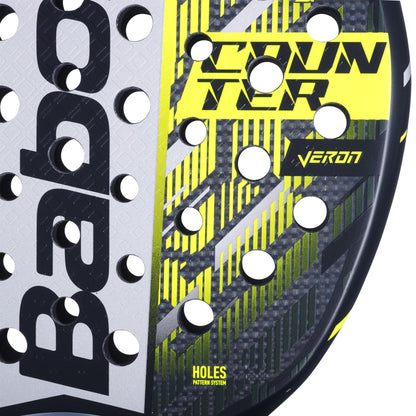 Close-up of the Babolat Counter Veron 2.5 Padel Racket, showing "COUNTER" and "VERON" in yellow, black, and gray with geometric patterns, circular holes, the Babolat logo on the left, and featuring Carbon Flex technology.