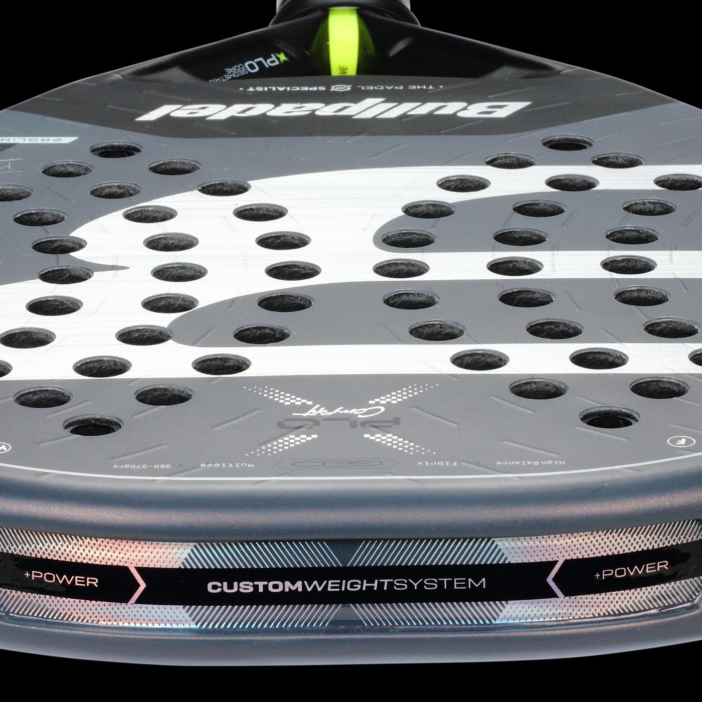 Close-up of the Bullpadel XPLO Comfort 2026 Padel Racket, featuring the Bullpadel logo, circular perforations, and “CUSTOM WEIGHT SYSTEM” plus “+POWER” text for explosive power and comfort.