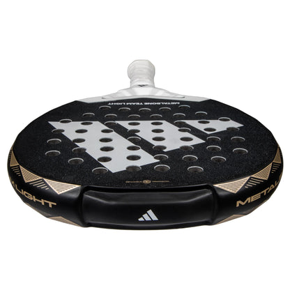 The lightweight adidas ADIDAS Metalbone Team Light 3.4 Padel Racket features a textured face with circular holes, a white handle, and gold accents. Designed for advanced players, the adidas logo is displayed clearly on the racket.