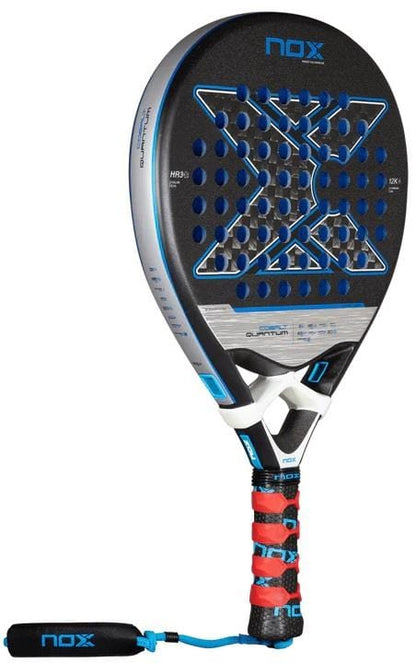 The NOX Luxury Quantum 12K Cobalt 2025 Padel Racket boasts a black and blue geometric design, perforated surface, red-and-black grip with wrist strap, and is crafted from premium 12K carbon fibre for top performance.