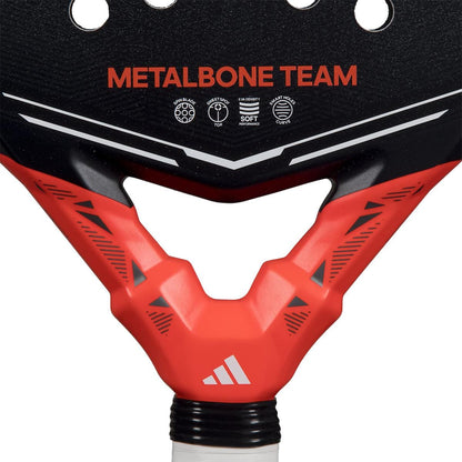 Close-up of the adidas Metalbone Team 2026 Padel Racket with “METALBONE TEAM” text, a striking red and black design, adidas logo near the handle, and advanced Spin Blade Gritt technology for enhanced control.