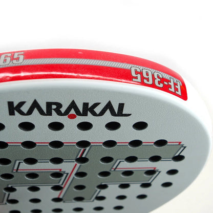 Close-up of the Karakal FF 365 Padel Racket by Karakal, featuring a white and red design, multiple holes, "FF-365" model number on the edge, and bold lettering—ideal for intermediate players seeking spin and control.