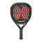 The Bullpadel Xplo 2025 Padel Racket from Bullpadel is displayed in black with a red design, featuring honeycomb holes and a textured handle, set against a white background.